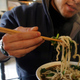 In this Nov. 20, 2003 file picture, a man uses chopsticks to eat noodles at a restaurant in Beijing, China.